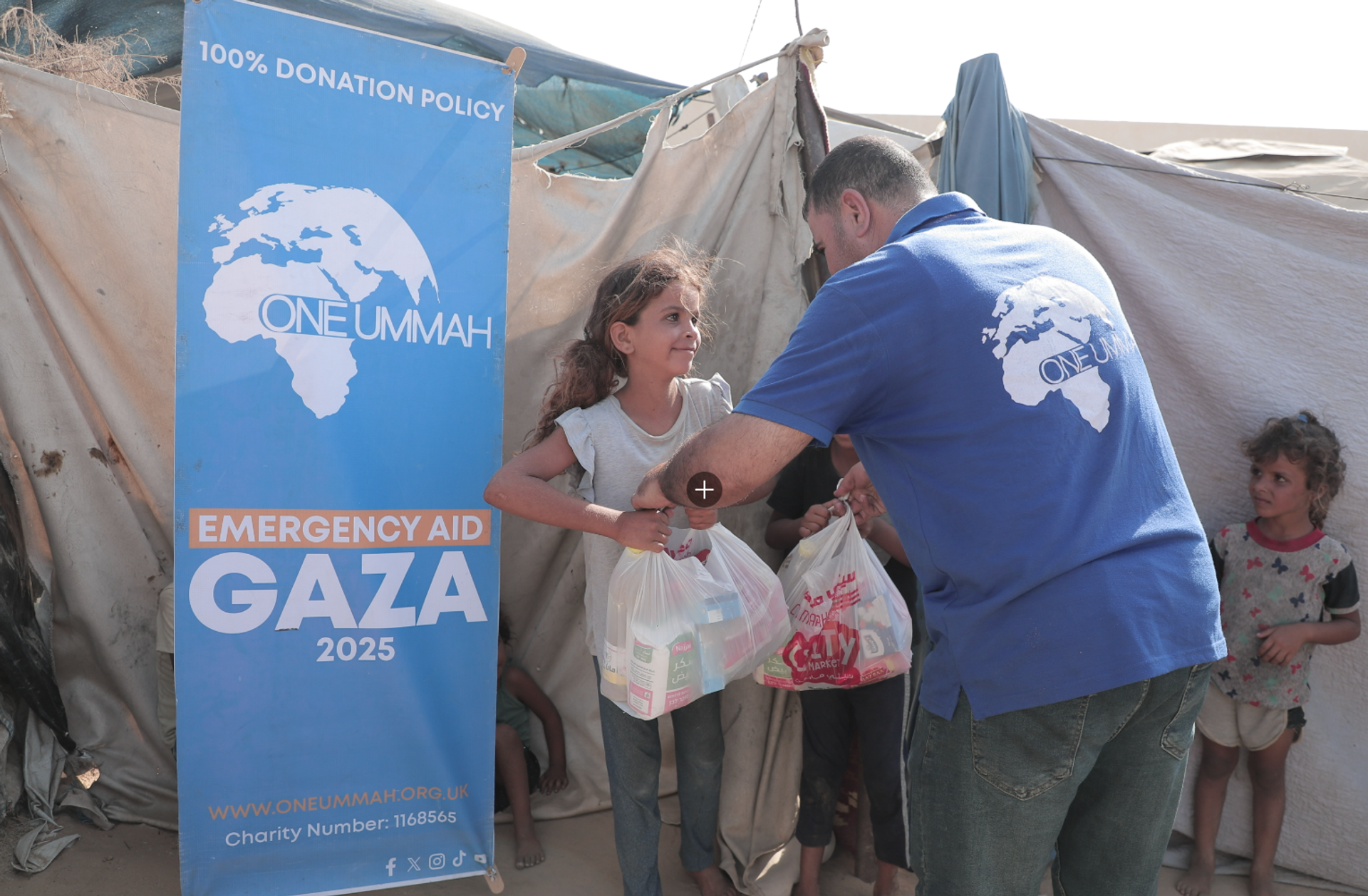 Gaza emergency aid pack on an older man’s back with destruction in the background.